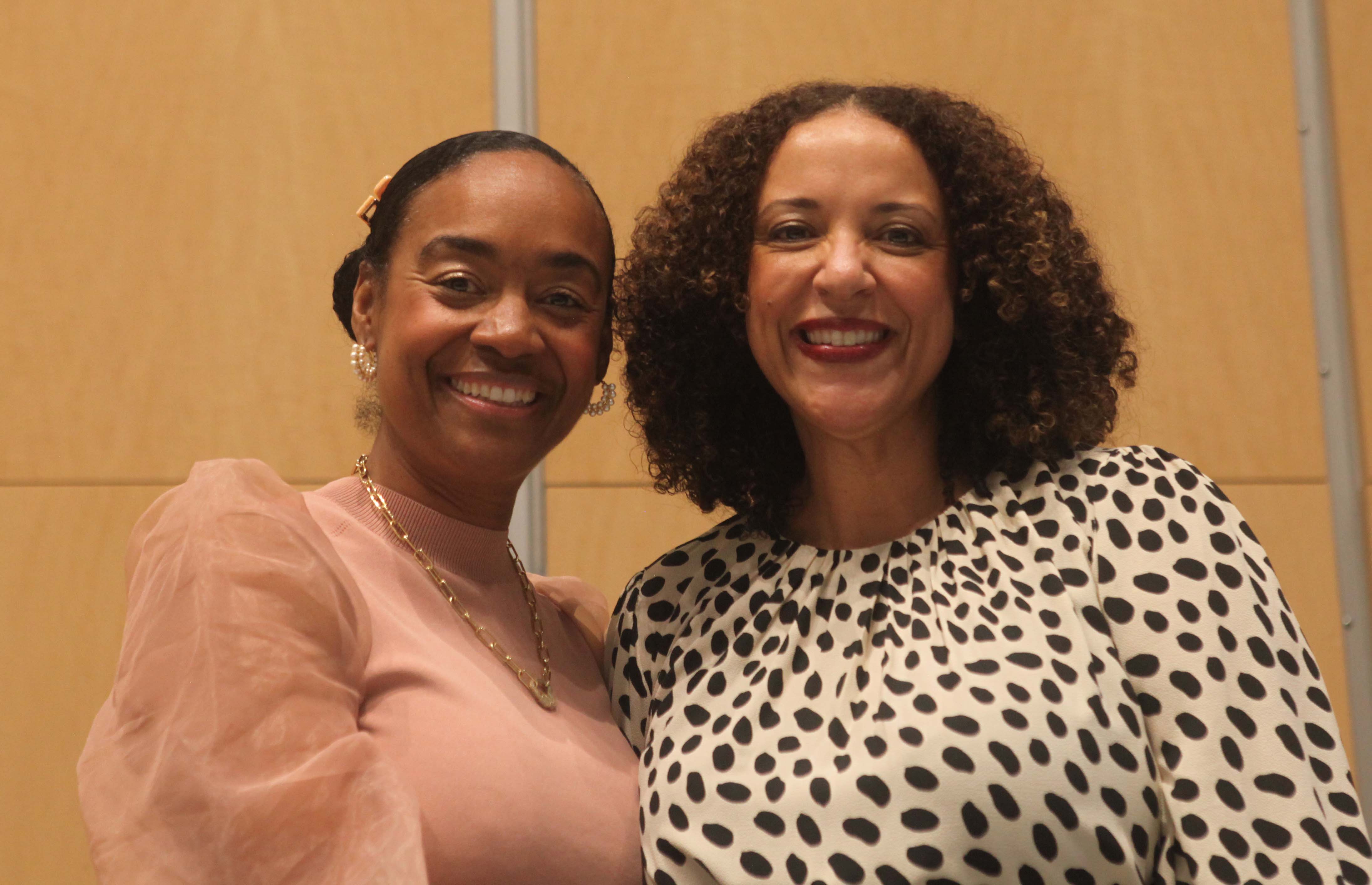 Maisha Winn on left and Janelle Scott on right both are smiling at the camera