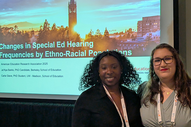 Doctoral student Ja'Nya Banks standing next to co author Carla Z Glave both are smiling at camera