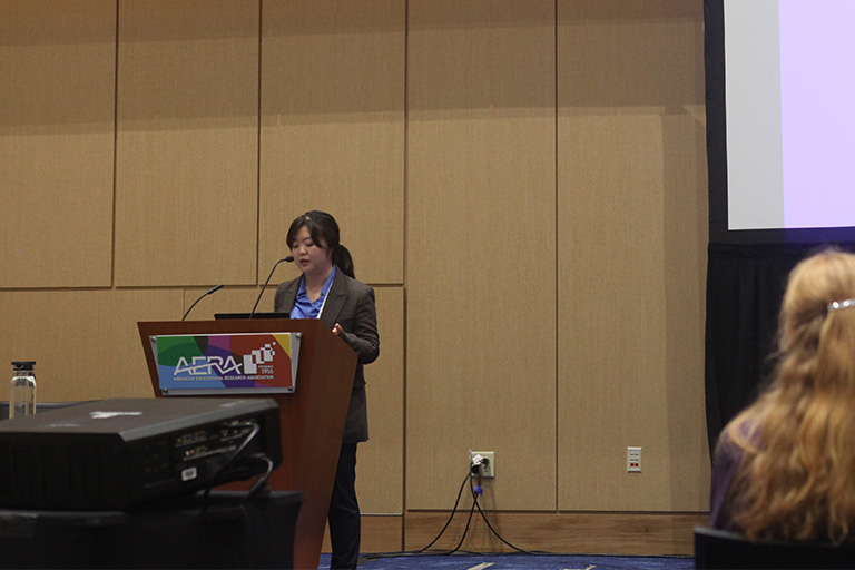hoyun kim at the podium discussing her research