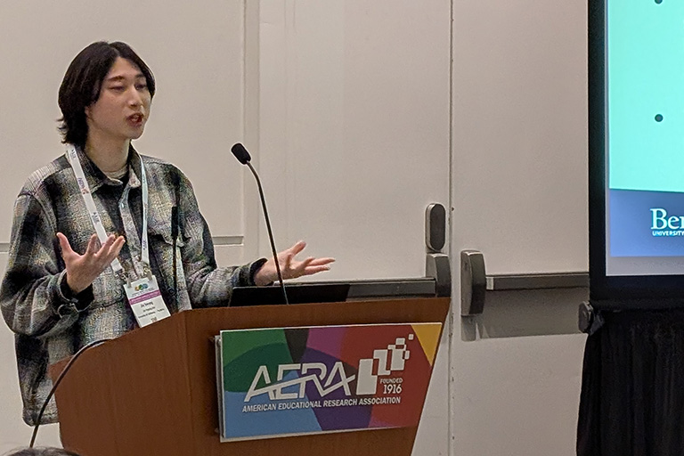 Jin Hyung Lim standing at the podium discussing his research