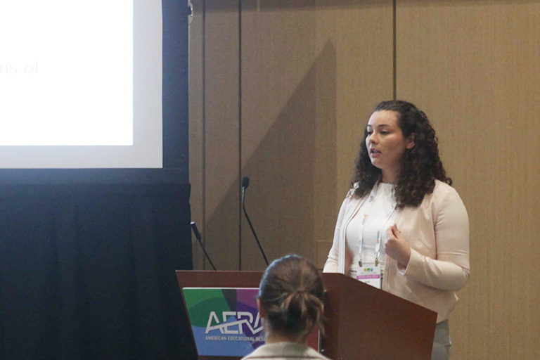 doctoral student sarah goulart at podium presenting research findings