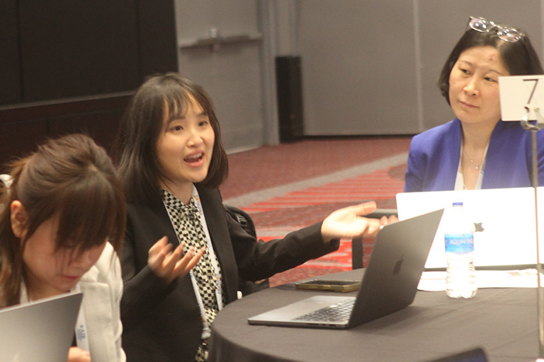 doctoral candidate Xueqin Lin at roundtable discussing her research findings