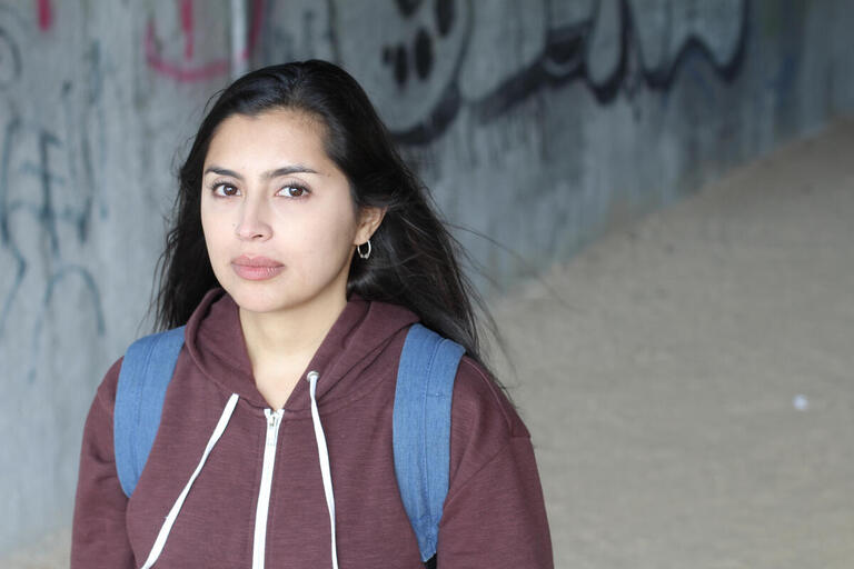 High School woman outside looking at camera, serious expression. high school woman looking at camera.