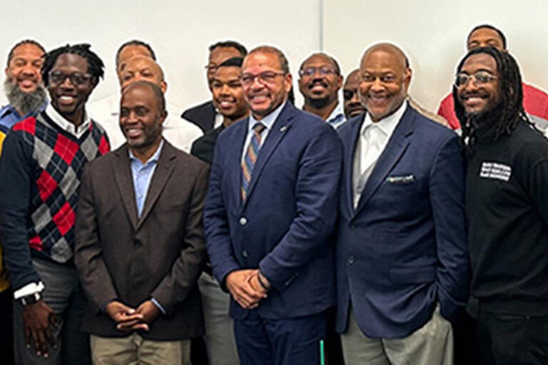 group of 25 black male leaders smiling at camera 