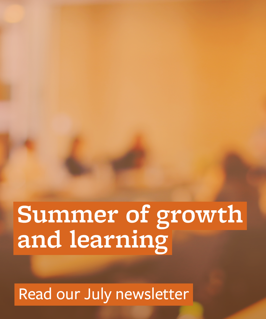 text reads "summer of growth and learning. read our July newsletter" over blurry photo of a room with people sitting at tables