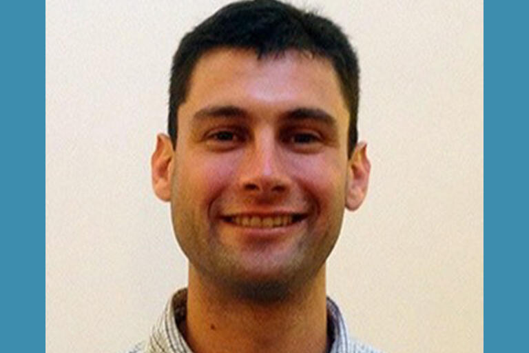 doctoral student michael bakal smiling at camera