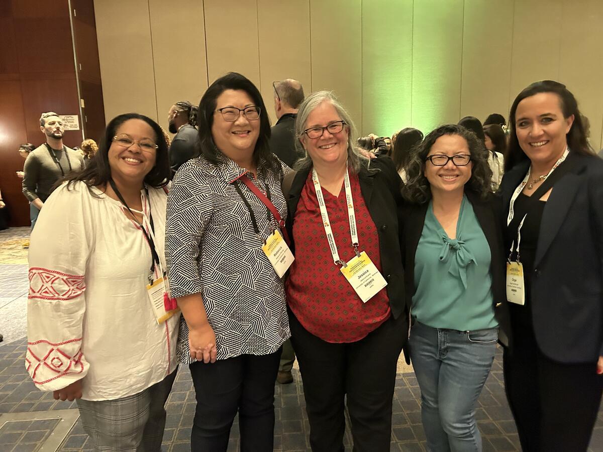 five people from the school leadership team standing next to each other smiling at camera