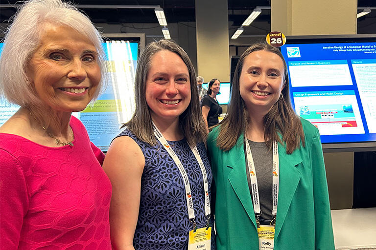 professor marcia linn and two students all smiling at camera