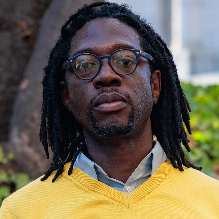 associate professor travis j bristol with stoic expression on his face looking at camera