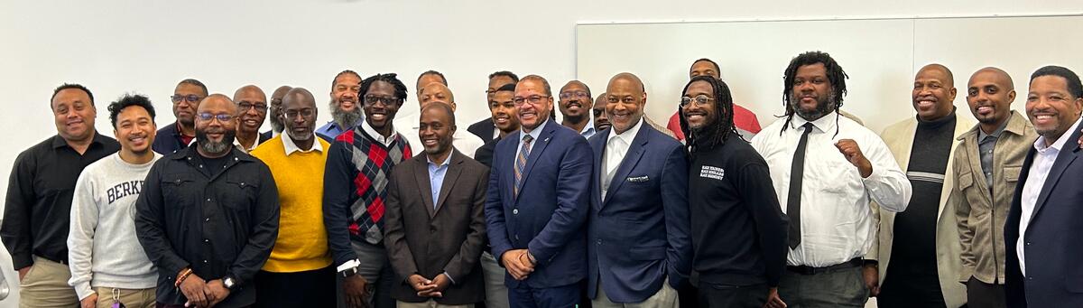 group of 25 black male educational leaders smiling at camera 