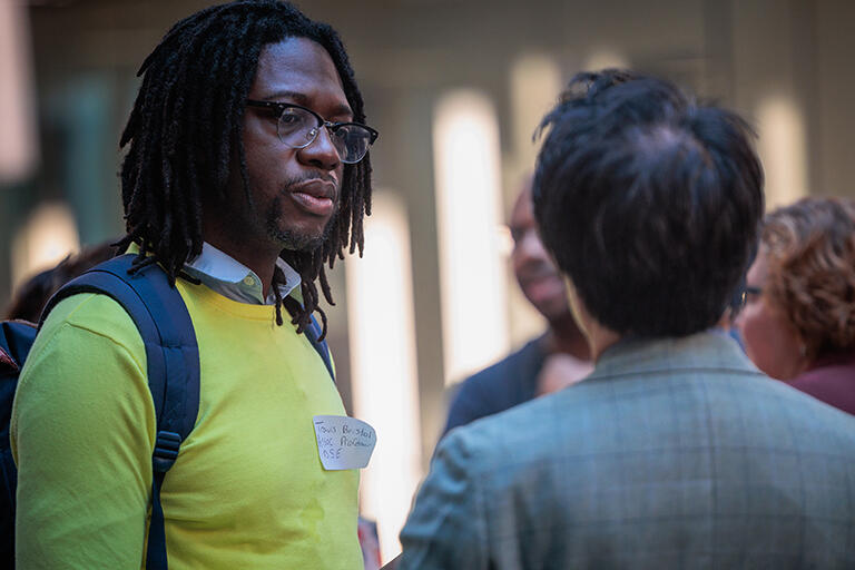 side view of associate professor travis bristol talking with another person