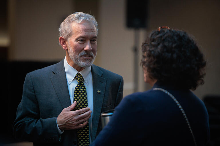 chancellor rich lyons chatting with an attendee