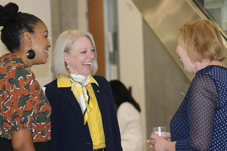 Dean michelle D young chatting with an open house attendee