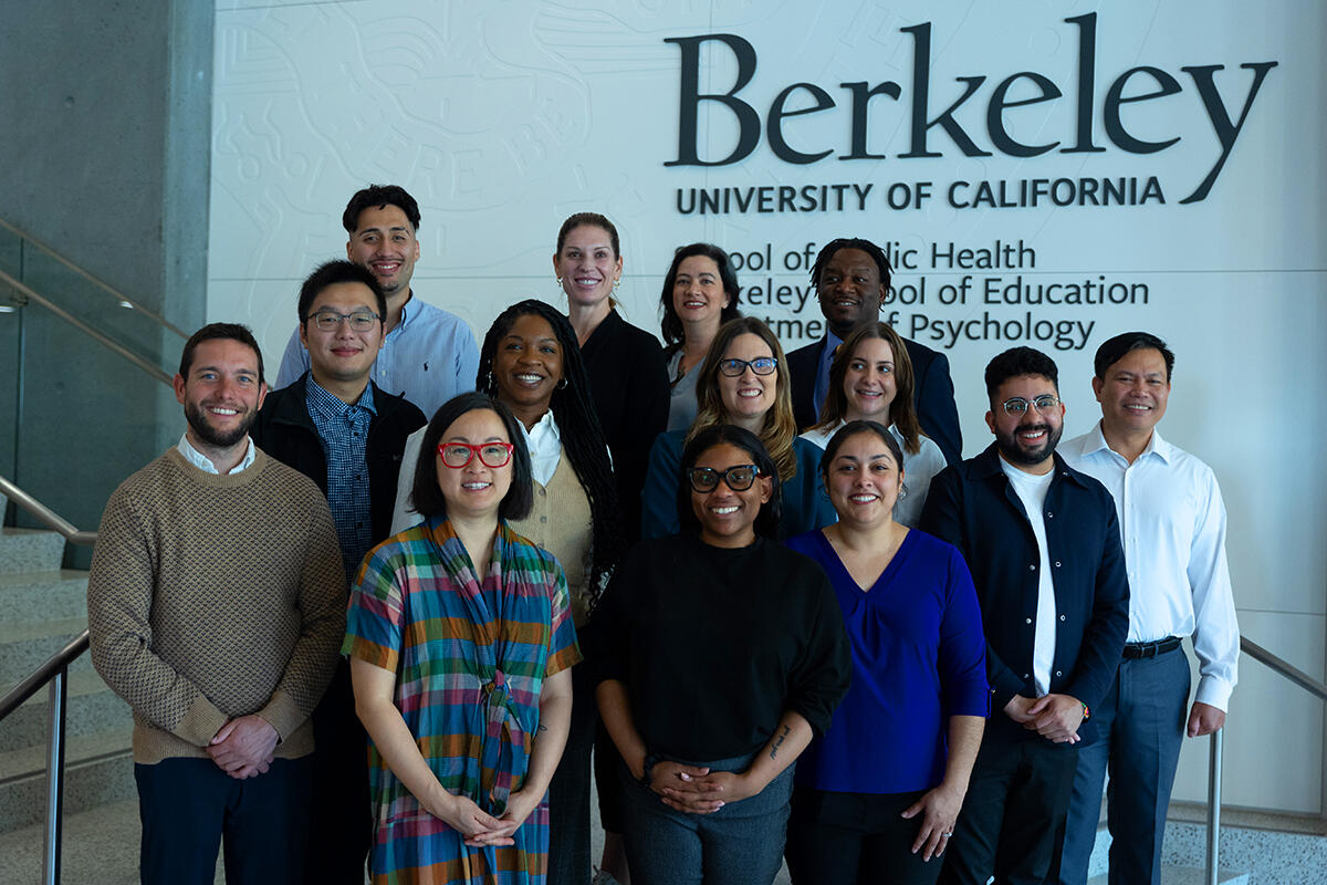 PLI Cohort 24 poses for a group photo on the stairs at Berkeley Way West