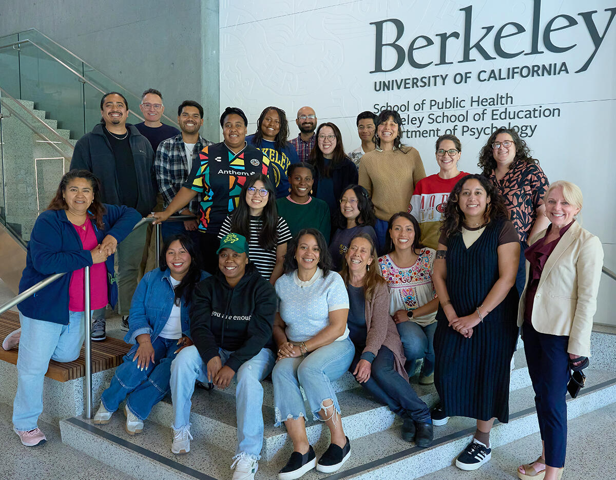 PLI Cohort 25 poses for a group photo with Dean Young on the stairs at Berkeley Way West