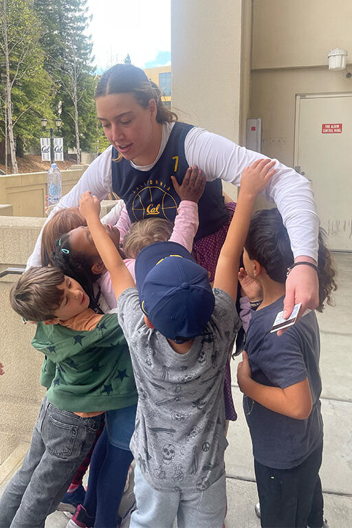 cal forward marta suarez and six first graders have a group hug