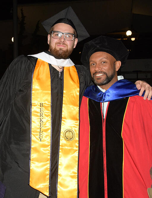master's degree student standing with teacher education program lead kyle beckham both smiling at camera