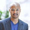 professor zeus leonardo portrait wearing blue v neck top and gray sport coat